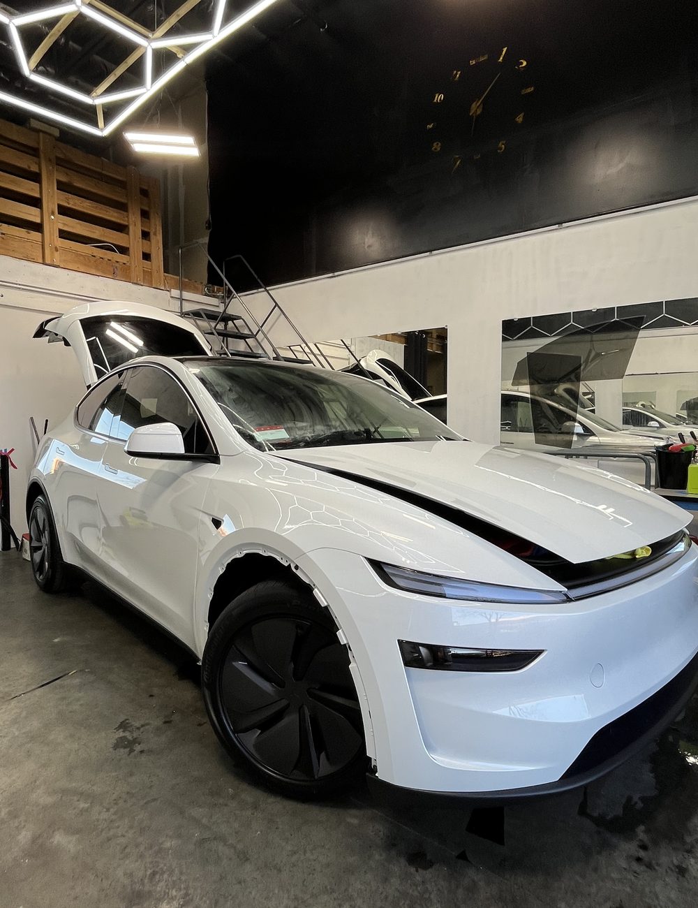 White Tesla Model Y with fresh tint at Vortex